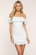 White eyelet mini dress front view – off-the-shoulder ruffled neckline smocked bodycon with ruffle hem on blonde European model